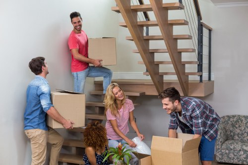 Professional piano removal team preparing a move in a Docklands apartment building