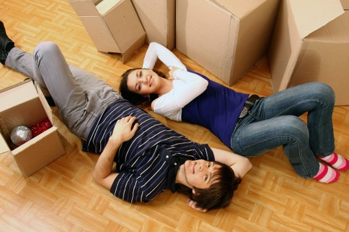 Movers carrying office equipment during a same-day relocation